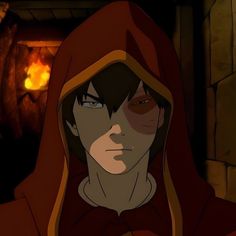 a man in a red hoodie standing next to a fire place and looking at the camera