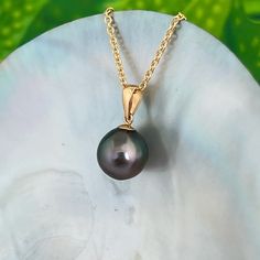 Classic Peacock Tahitian Pearl pendant set on a 18k gold bail . Simple , timeless and elegant. You can never go wrong with a simple Tahitian Pearl Pendant . Everyone should own one !  ✨You will get the exact pendant pictured .  ✨We offer various chain options in both 14k gold filled as well as solid 14k gold in different length options .  Description *Tahitian pearl : Size : 10.3mm Shape : Near Round  Color : Dark Peacock colors with a perfect balance of pink/purple hues and green overtones .  Quality : A or AAA+ Surface : Near Flawless, pearl had one subtle surface imperfection located on the back of the pearl  Luster : Very Good  *All of our pearls are hand picked directly from local farmers in Tahiti. We personally fly to Tahiti and hand pick each pearl . They are all certified and auth Pearl Pendant Set, Pearl Outfit, Tahitian Pearls Jewelry, Tahitian Pearl Pendant, Peacock Colors, Tahitian Pearl Necklace, Tahitian Pearls, Purple Hues, Pearl Size