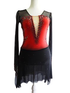 a red and black top with sequins on the back, sitting on a mannequin head