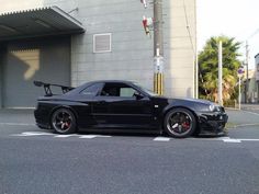 a black car parked in front of a building