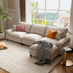 a living room filled with furniture and a large window overlooking the cityscape in the background