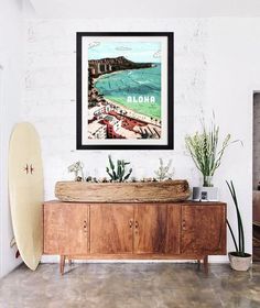 a surfboard sitting on top of a wooden cabinet