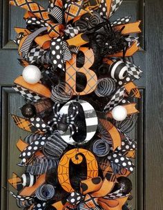 an orange and black wreath with the letter b on it