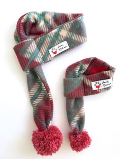 Red and Gray Plaid Dog & Cat Scarf   Love, Matisse fleece scarves for dogs and cats are made from an original scarf design. Each scarf is adorned with a playful yarn pom making this scarf a standout accessory!  Our pet scarves easily slip over your cat or dog's head and can be tightened or loosened by pulling on the pom end.  The scarves are  made from a durable and soft fleece fabric.  Get a matching scarf for yourself! Human scarves have two large pom poms on the ends of the scarf. Sizing  Mea Dog Scarf Pattern, Matisse Dog, Bully Xxl, Puppy Scarf, Bichon Havanais, Holiday Dog, Cat Scarf, Fleece Scarf, Dog Scarf