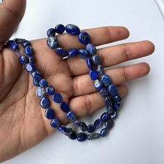 This listing is for Lapis Lazuli Smooth Tumble Oval Gemstone Beads, 7mm to 12mm Natural Lapis Lazuli Gemstone Beads, Sold As 18 Inch Strand, GDS2283/3. Gemstone : Lapis Lazuli  Size : 7mm to 12mm - 50 Pieces - 25.83gms Approx            Length : 18 Inch Strand   Color : Blue with Golden Flakes Item Code : GDS2283/3 (Measurements, number of pieces and weight are close to approximation.)  (Guaranteed Authentic Gemstone) I have made every attempt to portray the colors of the beads as accurately as possible. All photographs are taken in natural diffused daylight, without any enhancement of any sort. Colors do vary on different monitors; please keep this in mind when viewing the beads, gemstones or supplies. Also all pictures have been magnified to show details.  Questions/ Comments are most we Lapis Lazuli Gemstone, Lapis Lazuli, Gemstone Beads, Accessory Gift, Gems, Electronic Accessories, Purses And Bags, Gemstones, Beads