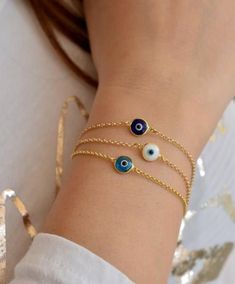 Evil eye symbolizes good luck and spiritual protection. It is believed that the eye protects it's owner from negative energy and the jealousy. An elegant bracelet that you can wear all day with your other favorite bracelets. Makes the perfect gift for your self or your loved ones!  Available in solid 925 Sterling Silver or 14K Gold Filled. Product Details: * Made to order * Evil Eye murano bead (8mm) same on both sides * Material : High quality solid 925 Sterling Silver chain and findings * Diamond Cut Chain * Finish : Sterling Silver - 14K Gold Filled * Anti-tarnish / Does not fade * 100% Hypoallergenic * Safety Clasp Size : * 6 inch / 15cm * 6.5 inch / 16.5 cm * 7 inch / 17.5 cm * 7.5 inch / 18.5 cm * 8 inch / 20 cm Choose your length bracelet from the drop down menu. The length of the b Evil Eye Gold Bracelet, Gold Arm Band, Greek Tradition, Eye Gift, Greek Evil Eye, Gold Armband, Spiritual Protection, Greek Jewelry, Protection Bracelet