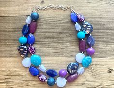 💞One of a kind & ready to ship💞 Dress up any outfit - great for a night out or with a white tee! 17 Inch Necklace with a 4 inch silver extender chain and silver lobster clasp. This is an eclectic bunch of acrylic beads in shades of blue and purple 😍 A total conversion starter! Thank you for supporting American small business! *Smoke and pet free home!* I ship 6 days a week! This particular necklace one of a kind and is READY TO SHIP! Thank you for browsing my store! Chunky Necklaces Statement Crystal, Party Necklaces With Colorful Blue Beads, Blue Necklaces With Colorful Beads For Party, Blue Large Beads Necklace For Party, Adjustable Blue Bib Necklace For Party, Adjustable Blue Bib Necklace With Colorful Beads, Blue Adjustable Bib Necklace With Round Beads, Blue Costume Jewelry Necklace With Large Beads, Adjustable Blue Bib Necklace With Round Beads