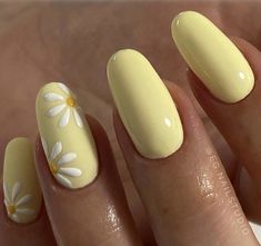 a woman's hand with yellow and white flowers on it