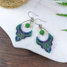 Hold the power of the ocean with these diffuser earrings of the sea 🌊 Handmade to order with love 💙💚 ❃ 1 pair of macrame earrings featuring a green lava bead. Lava stone is porous making it great to hold a drop or two of your favorite essential oils!  ❃ Knotted with durable, nylon cord (vintage jade, teal, dark teal, indigo, lilac, fern green) ❃ Choose your ear hook style. (All hooks come with clear backings except for the leverback hooks) :  1. Stainless Steel French hooks: These are Hypoallergenic stainless steel and will never tarnish.  2. 925 Sterling Silver french hooks: Great for metal allergies. Please note: All Sterling Silver has a small amount of copper in it and therefore will eventually slightly discolor without proper care. 3. Leverback: These hooks are hypoallergenic stain Bohemian Macrame Beaded Earrings For Festivals, Green Macrame Dangle Earrings, Green Bohemian Macrame Earrings, Bohemian Green Macrame Earrings, Lava Earrings, Blue Skulls, Cactus Earrings, Unique Jewelry Gifts, Macrame Earrings