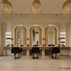 the interior of a hair salon with chairs and mirrors