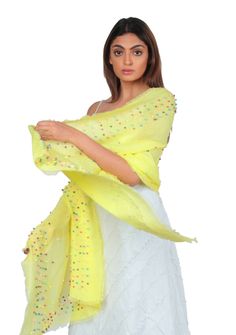 Infuse your look with a vibrant burst of color by styling yourself with this yellow linen and modal blended scarf. Its lightweight and breathable fabric makes it an ideal and easy-to-wear accessory. The scarf is adorned with fun and quirky multi-colored rudraksha pearls, delicately scattered across and as an inner border, adding a playful and whimsical touch to your outfit. Stand out from the crowd and embrace your individuality with this enchanting scarf that effortlessly combines comfort, styl Burst Of Color, Fall Collections, Summer Collection, Multi Colored, Occasion Wear, Breathable Fabric, Casual Wear, Cashmere, Unique Designs