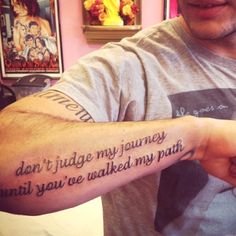 a man with a tattoo on his arm that says don't judge my journey until you've walked my path