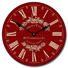 a red clock with roman numerals on it