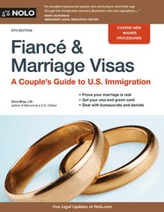 two gold wedding rings sitting next to each other on top of a blue book cover