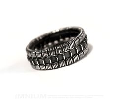 two black and silver rings sitting on top of each other