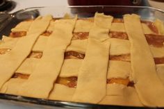 an uncooked pie sitting on top of a pan filled with pastry toppings