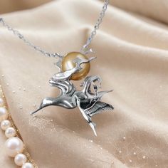 The silver necklace is adorned with a beautiful pendant featuring a subset and a crane, with the sun made of pearl. The pendant captures the essence of the ancient Chinese poem, "晓看天色暮看云，行也思君坐也思君", which can be translated as "At dawn, I gaze upon the sky; at dusk, I watch the clouds. Whether walking or sitting, I think of you, my love." The subset symbolizes the beauty of nature and the ever-changing sky. It serves as a reminder to appreciate the fleeting moments and the passage of time. The crane represents longevity, grace, and fidelity. Its presence adds elegance and a sense of tranquility to the necklace. At the center of the pendant, the sun made of pearl radiates a soft and gentle glow. The pearl symbolizes purity, wisdom, and prosperity. Its lustrous surface reflects light, evoking Poem Themes, Chinese Poem, Love Poem, Crane Bird, Silver Pearl Necklace, San Rafael, Ancient Chinese, Animal Jewelry, Silver Pearls