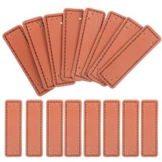 six pieces of tan leather with stitching on each side and five rows of small holes in the middle