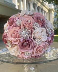 a bridal bouquet is sitting on a glass platter