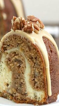 a bundt cake on a plate with a fork and an apple in the background