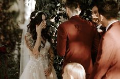 a bride and groom are standing in front of the altar