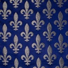 a blue and silver fabric with fleur de lis on it