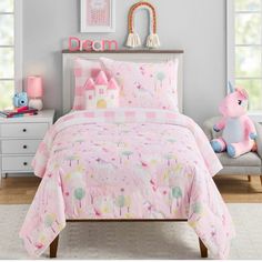 a child's bedroom with pink and white bedding, unicorns and castle