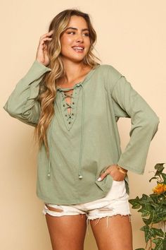 Detail: Lace up top with long sleeves, raw seam and rounded side slits. Chic Relaxed Fit Top With Frayed Hem, Chic Tops With Frayed Hem And Relaxed Fit, Cotton Long Sleeve Top For Day Out, Long Sleeve Tops With Frayed Hem For Layering, Long Sleeve Tops For Spring Layering, Relaxed Fit Long Sleeve Top With Frayed Hem, Long Sleeve Tops With Frayed Hem And Relaxed Fit, Chic Long Sleeve Loungewear Top, Oversized Tops With Frayed Hem For Fall