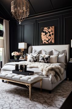 a bedroom with black walls, white bedding and chandelier hanging from the ceiling