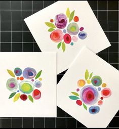 three cards with flowers painted on them