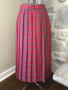 80's Women's pleated plaid skirt. Longer style and hits below the knee. Zipper closure with top button to secure.  Skirt Measurements (Approximate): Waist: 30 inches Length: 31.5 inches Classic Pleated Plaid Skirt, Fitted Pleated Plaid Skirt, Scottish Plaid Pleated Bottoms, Scottish Style Fitted Plaid Pleated Skirt, Pleated Plaid Skirt, Skirt Measurements, Womens Skirts, Plaid Skirt, Long Style