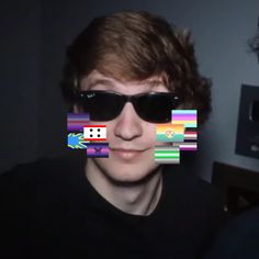 a young man wearing sunglasses and smiling at the camera with an image of dice on his face