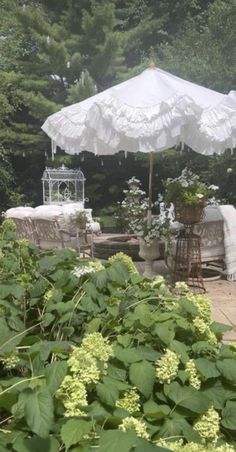 an outdoor patio with tables, chairs and umbrellas