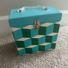 a blue and green box sitting on the floor