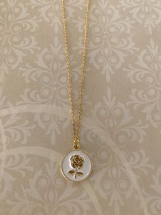 "Dainty and really sweet white and gold tone rose necklace. Dimensional gold tone rose is on a white enamel background. Pendant measures 5/8\" in diameter and is on an 18\" chain. Also available with red background under the following listing: https://www.etsy.com/listing/1018865133/gold-rose-necklace-gold-rose-jewelry?ref=listings_manager_grid ★ Want to see more? Please visit my shop at: https://www.etsy.com/shop/DesignsByPeg" Dainty Rose Necklace, Rose Necklace Gold, Gold Rose Necklace, White Necklaces, Black Gold Necklace, Dainty Rose, Vehicle Decor, Vehicle Maintenance, Fancy Jewelry Necklace