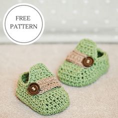 two green crocheted baby shoes with brown buttons