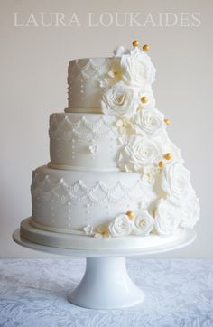 a white wedding cake with flowers on top