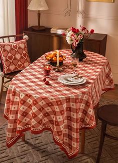 a dining room table covered in red and white checkered cloth