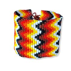 Lovely handmade wide, flat, Beaded Bracelet, black, orange and yellow colour, zig zag design. Adjustable size. Multi colour.  Bracelet size it's adjustable from 17 cm to 19 cm by 5 cm wide. Zig Zag Design, Boho Chic Bracelets, Cotton Bracelet, Orange Bracelet, Loom Bracelet, Chic Bracelet, Yellow Colour, Bead Loom Patterns, Loom Bracelets