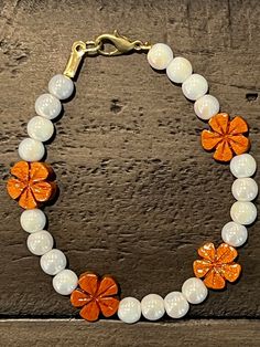 Evoking the beauty and warmth of Hawaii, this approximately 7-inch bracelet is made with white iridescent round glass beads accented with light wooden plumeria beads. With a lobster claw clasp, this bracelet will brighten your wrist and your day no matter what the weather outside may bring. Plumeria | White iridescent | Hawaiian-inspired | Beach-inspired | Unique jewelry | Tropical-inspired | Elegant bracelet | Stylish bracelet | Beaded bracelet | Unique bracelet | Gift for her | Hawaiian jewelry | Hawaiian bracelet Handmade White Crystal Spiritual Bracelet, Handmade White Spiritual Crystal Bracelet, Handmade White Crystal Round Bracelet, Handmade White Crystal Bracelet, White Crystal Bracelet With Colorful Round Beads, Handmade White Crystal Bracelet With Flower Shape, Handmade White Crystal Bracelet In Flower Shape, Handmade White Pearl Bracelet For Jewelry Making, Handmade White Crystal Flower Bracelet