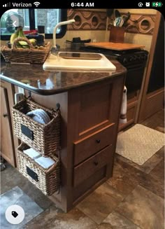 a kitchen island with baskets under it