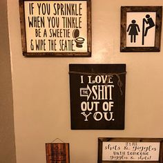 the bathroom is decorated with various signs on the wall