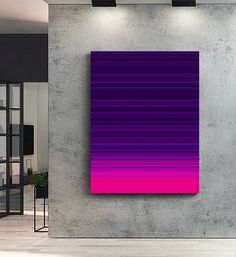 an abstract painting is displayed on the wall in front of a large room with concrete walls and flooring