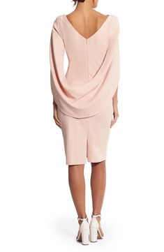 A cocktail dress made of stretchy, asymmetrically draped crepe features cape sleeves that encourage you to embellish every story with a dramatic flourish. 41" length (size 8) Hidden back-zip closure Bateau neck Cape sleeves Lined 94% polyester, 6% spandex Dry clean Made in the USA of imported fabric