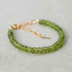 Want to save 15% off your first order? Sign up for our newsletter by visiting our website and filling out the pop up form. Receive a code by email, then send us that code through Etsy messages to save 15% off your ETSY order, sign up here: www.earthlyabundancejewelry.com  Peridot: heart chakra, willpower, surrender, clarity, happiness, moving forward D E T A I L S △ Handmade in Vancouver △ AAAA+ Peridot 5.5mm (roughly) △ Adjustable: fits roughly 6-8" △ 14K Gold filled clasp and extender  △ Gemstones are genuine  Q U A L I T Y  The upmost quality and care goes into sourcing each and every material I use. Gemstones are sourced from Jaipur and Rishikesh, India and I hold stronger connections to my suppliers. I use 100% authentic gemstones, this is our guarantee (no synthetics or imitation sto Dainty Green Peridot Jewelry, Lime Green Peridot Jewelry For May Birthstone, Hypoallergenic 14k Gold Green Jewelry, Hypoallergenic Green 14k Gold Jewelry, Green Peridot Round Bracelets, Green Peridot Bracelet Jewelry, Green Peridot Bracelet, Rishikesh India, Peridot Bracelet