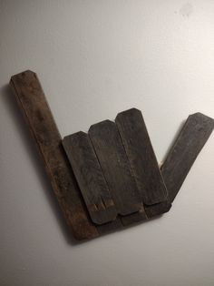 a piece of wood sitting on top of a white wall