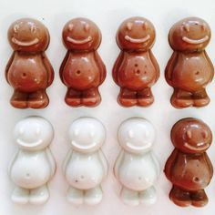 there are many small brown and white teddy bears in the same row, one is larger than the other