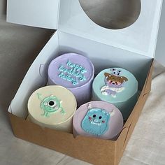 a box filled with different colored cakes in it's cardboard packaging on top of a table