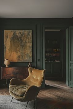 a living room with green walls and a chair in front of a painting on the wall