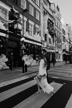 a man and woman walking across a cross walk